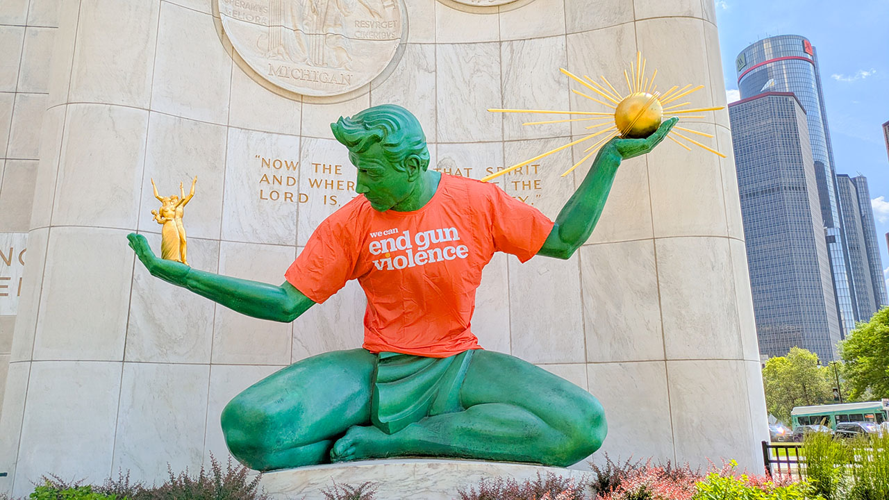 Spirit of Detroit with an orange jersey.